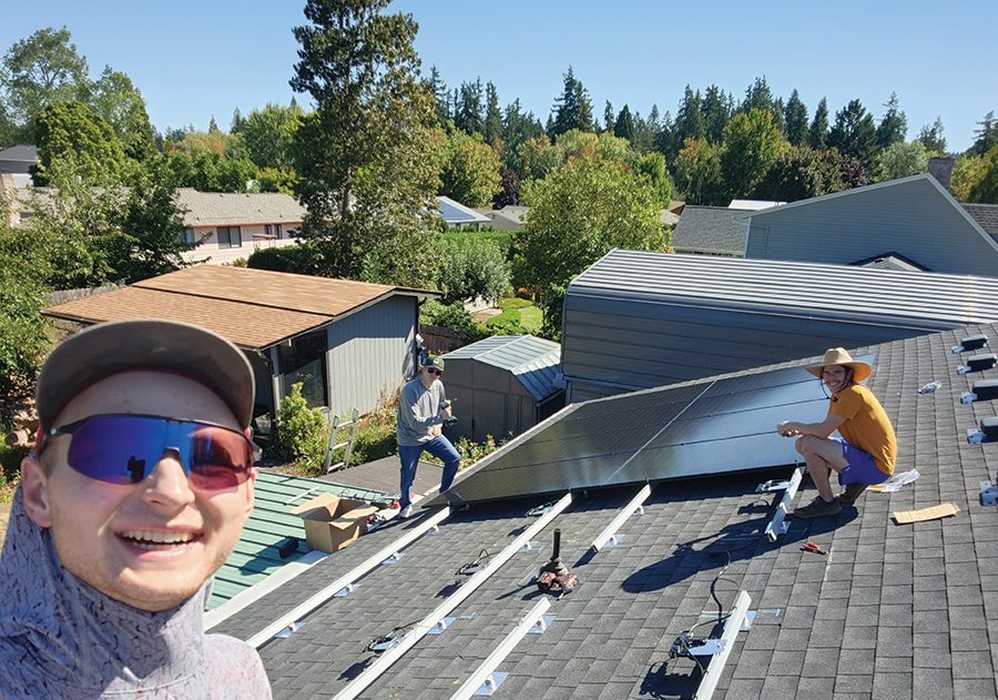 Sunni Schoepe (left) with helpers during a rooftop solar installation. Many guided DIY projects are collaborative, with homeowners taking an active role in the work while relying on professional design, plans, and technical guidance.