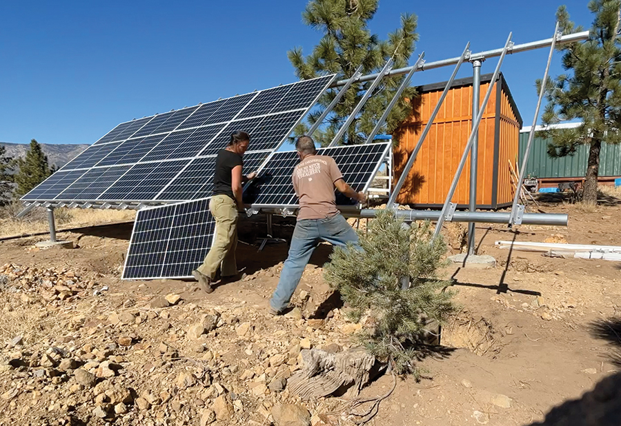 Mike O’Dell and his wife Rose install panels on a ground-mounted solar array at their off-grid property. Their project reflects the owner-builder side of the DIY solar market: customers taking an active role in building their own power infrastructure while relying on professional design and support.
